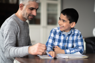 Muslim father helping son with homework