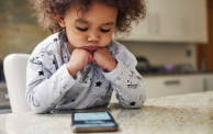 a toddler using a smart phone