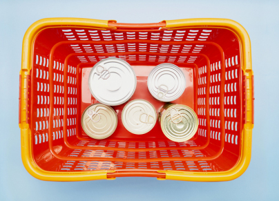 canned food in red shopping basket 