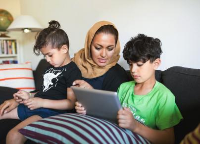 mother with two kids on tablet 