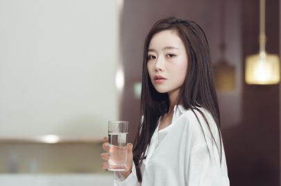 Beautiful woman holding a glass of water