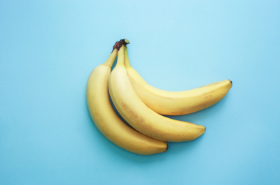 two bananas on a light blue background