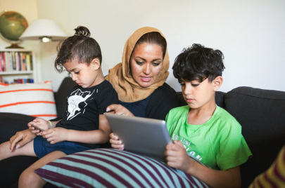 mother with two kids on tablet 