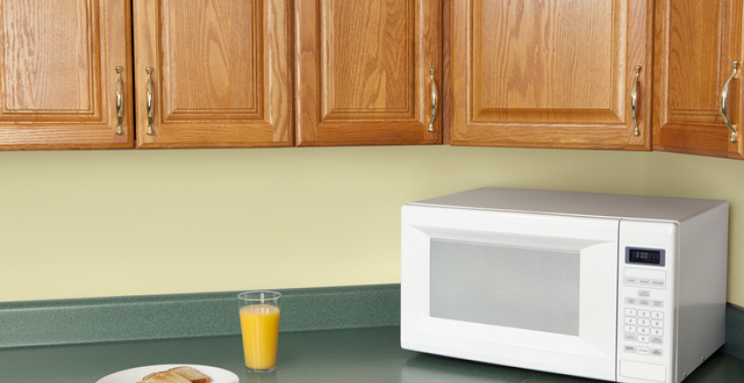 Orange Juice and Toast beside a microwave 
