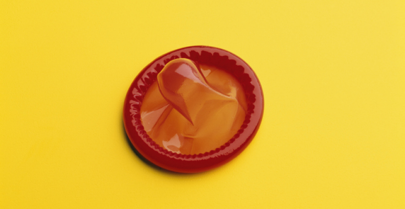 red condom on a yellow background
