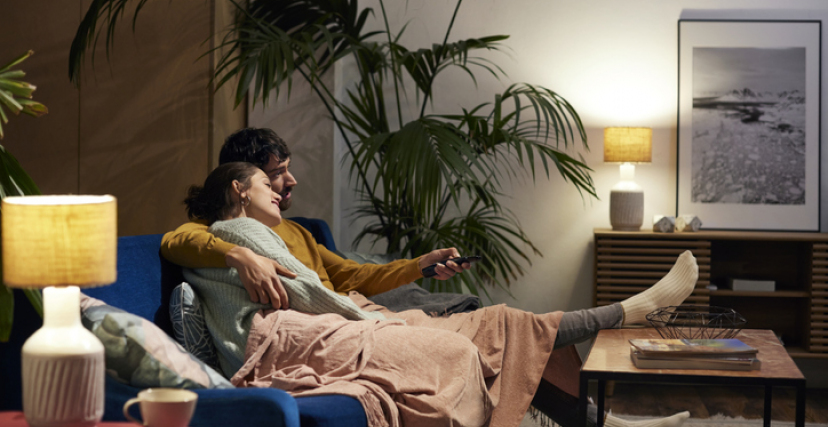 Mid Adult Couple Watching TV In Living Room