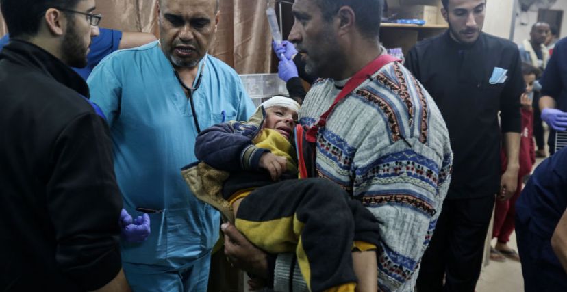 مسعفون يعالجون جرحى في مستشفى شهداء الأقصى بدير البلح (GETTY)