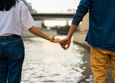 France, Paris, couple holding hands at river Seine
