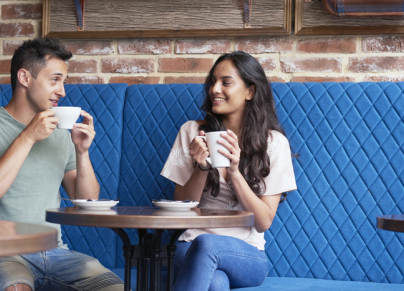 a couple in a cafe drinking coffee 