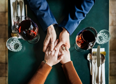 Aerial View Of Couple Holding Hands At Restaurant Table