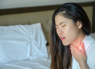 Close-up of woman having sore throat or throat pain.