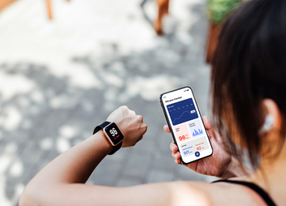 Young Woman Using Fitness Tracker App On Smart Watch