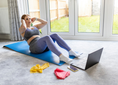 woman exercising in front of laptop 