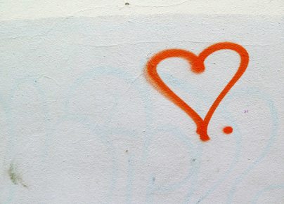 A red love heart spray painted on a wall in Paris