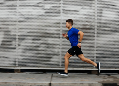 Sportsman running against metal wall