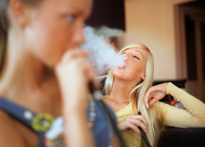 Young Woman Smoking Hookah