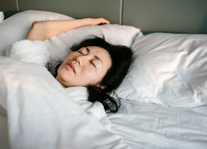 Sick and tired woman sleeping in the bed in early morning