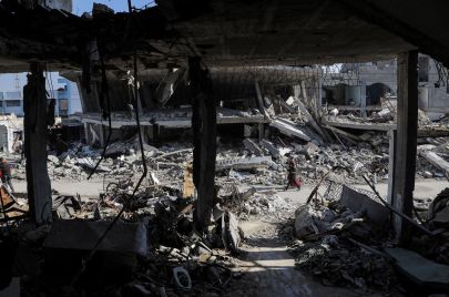 فلسطينيون وسط ركام المباني المدمرة في غزة